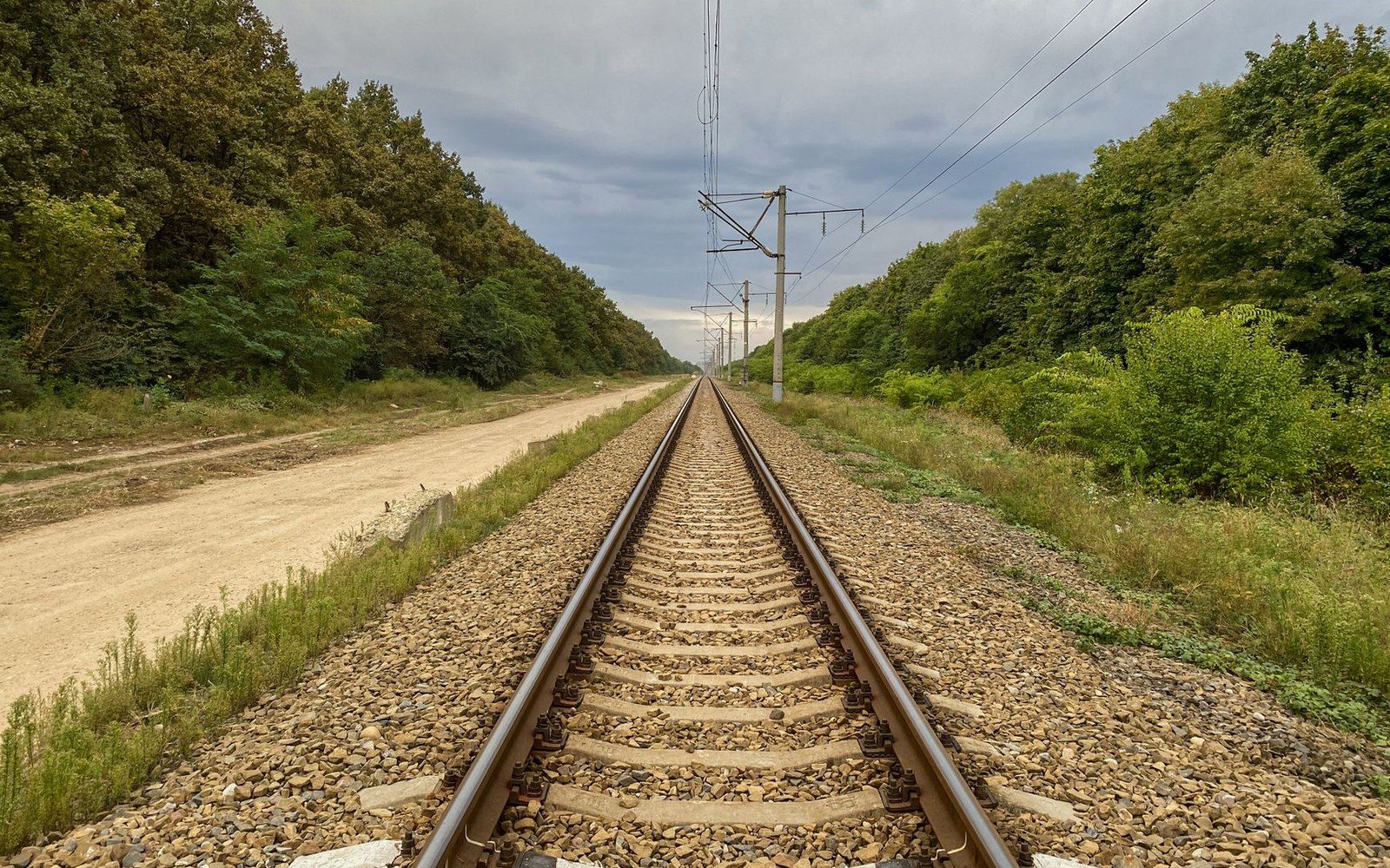 Rail track running straight to a low horizon, grey light